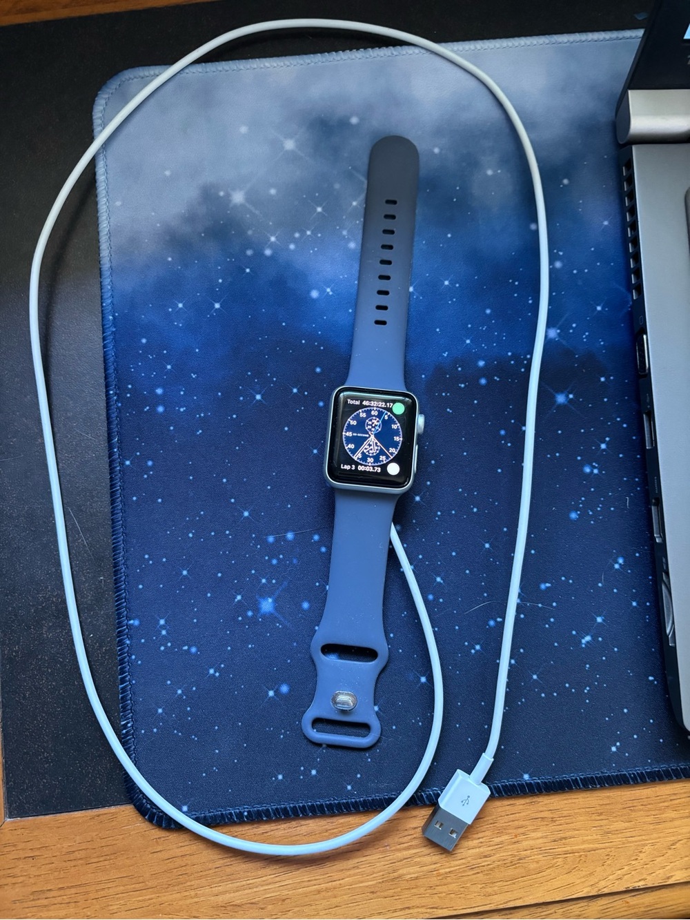 Apple Watch with Blue Sport Band and Light Blue Charging Cable